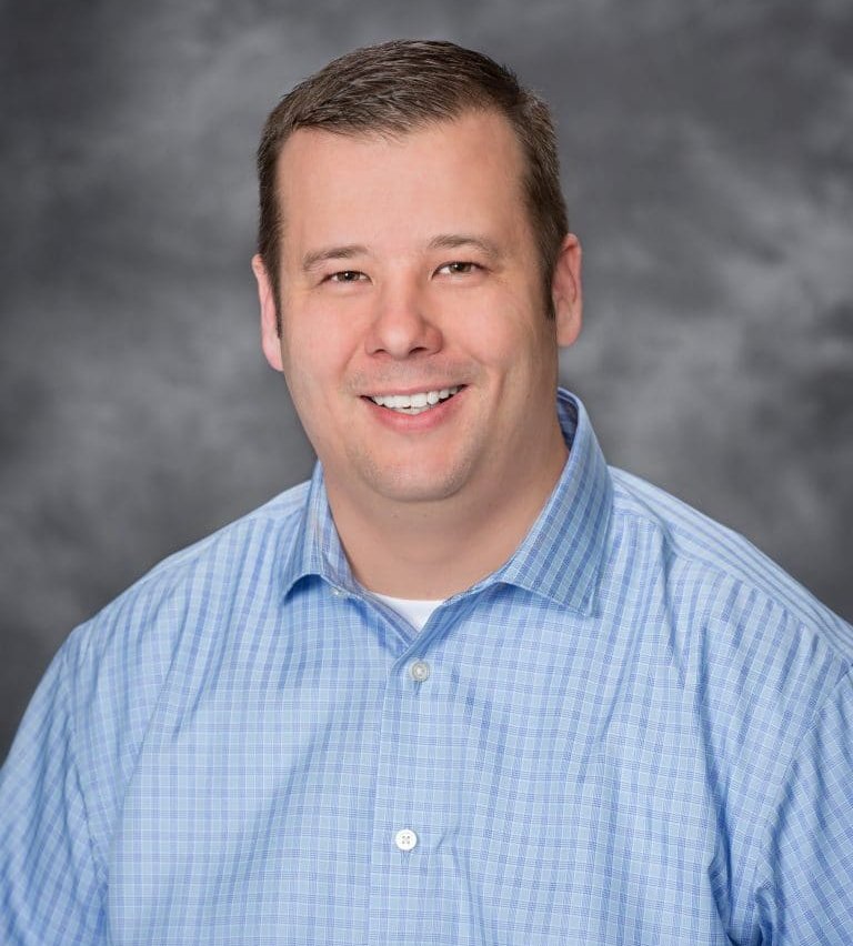 Ryan Holden, H.A.D., of Golden State Hearing Aid Center smiling in a friendly headshot